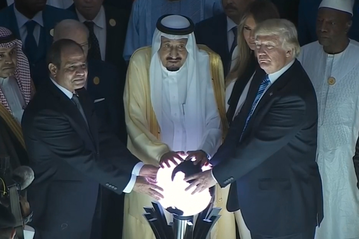 Donald Trump putting his hands on a weird glowing orb a few years ago. 